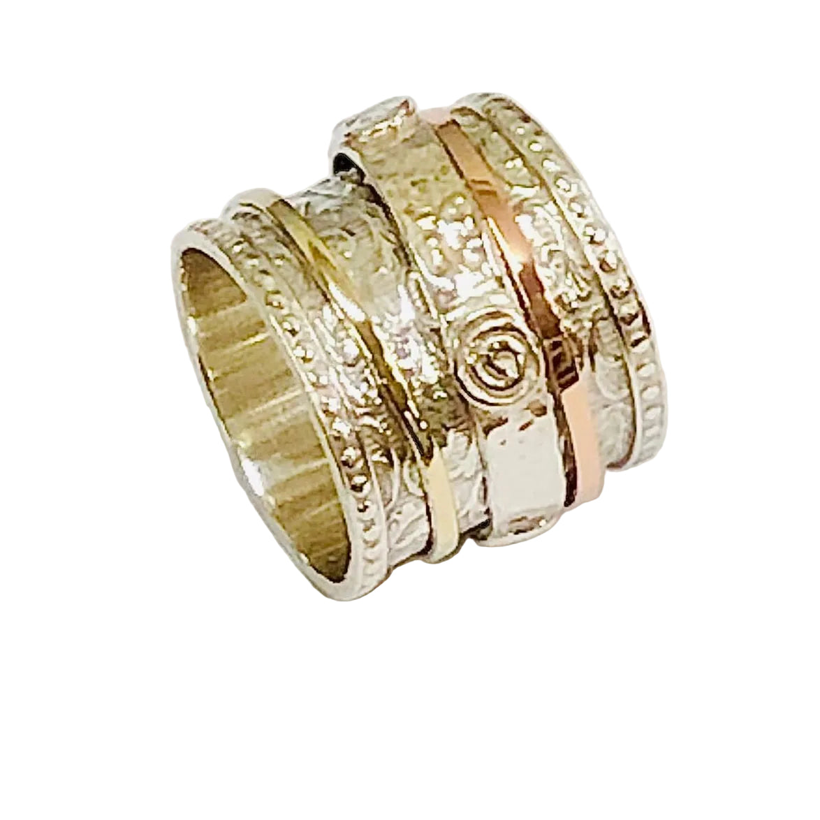 Set of gold rings with textured bands on a light gray background