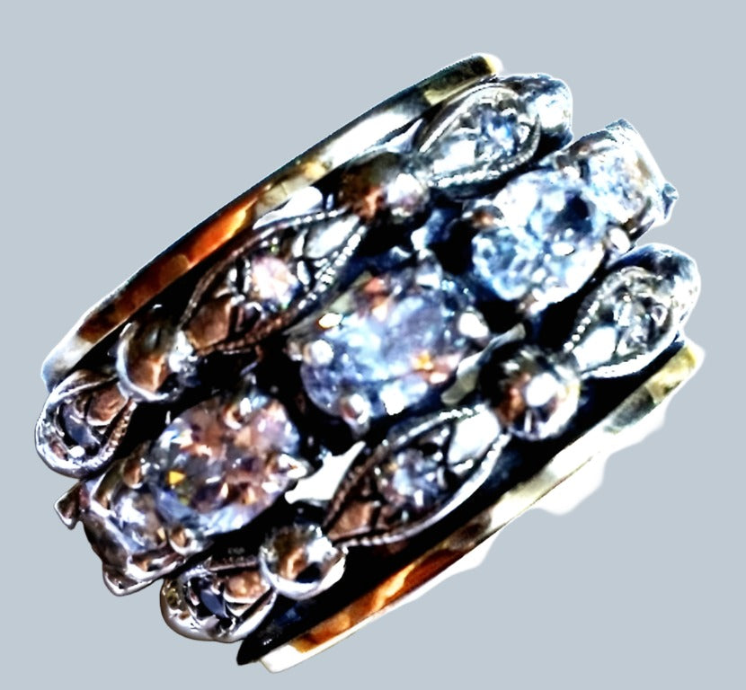 Bluenoemi rings Spinner ring for woman made of silver and gold. The ring is set with cz zircons.