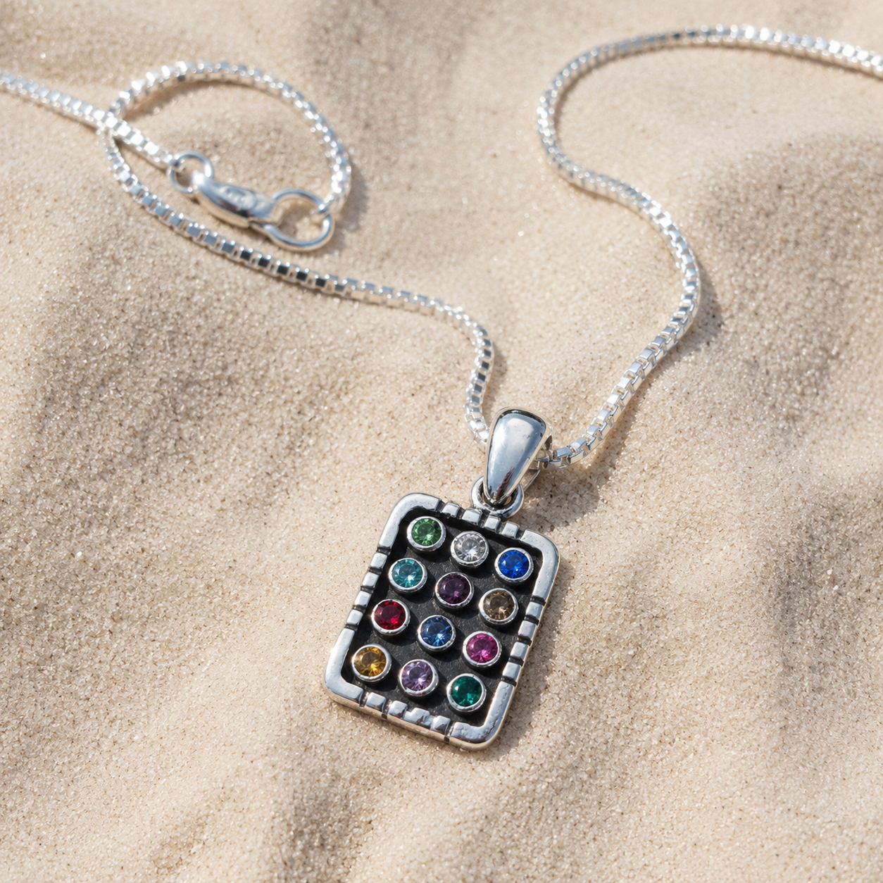 Sterling silver Hoshen necklace displayed on neutral fabric