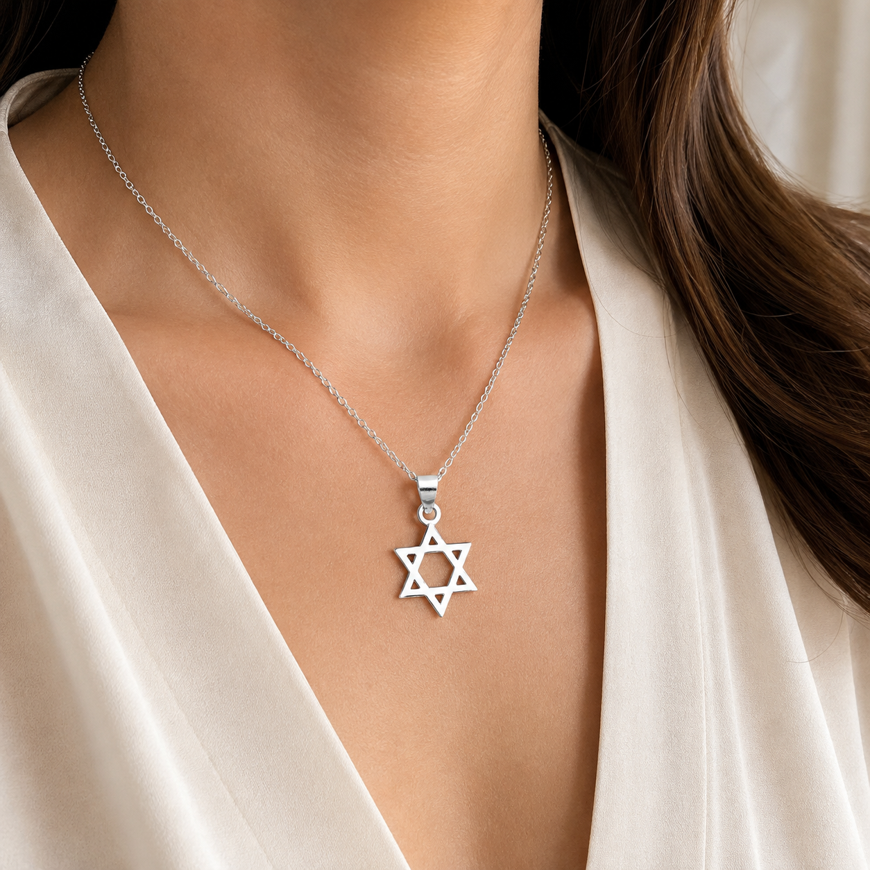 Star of David silver necklace on a woman