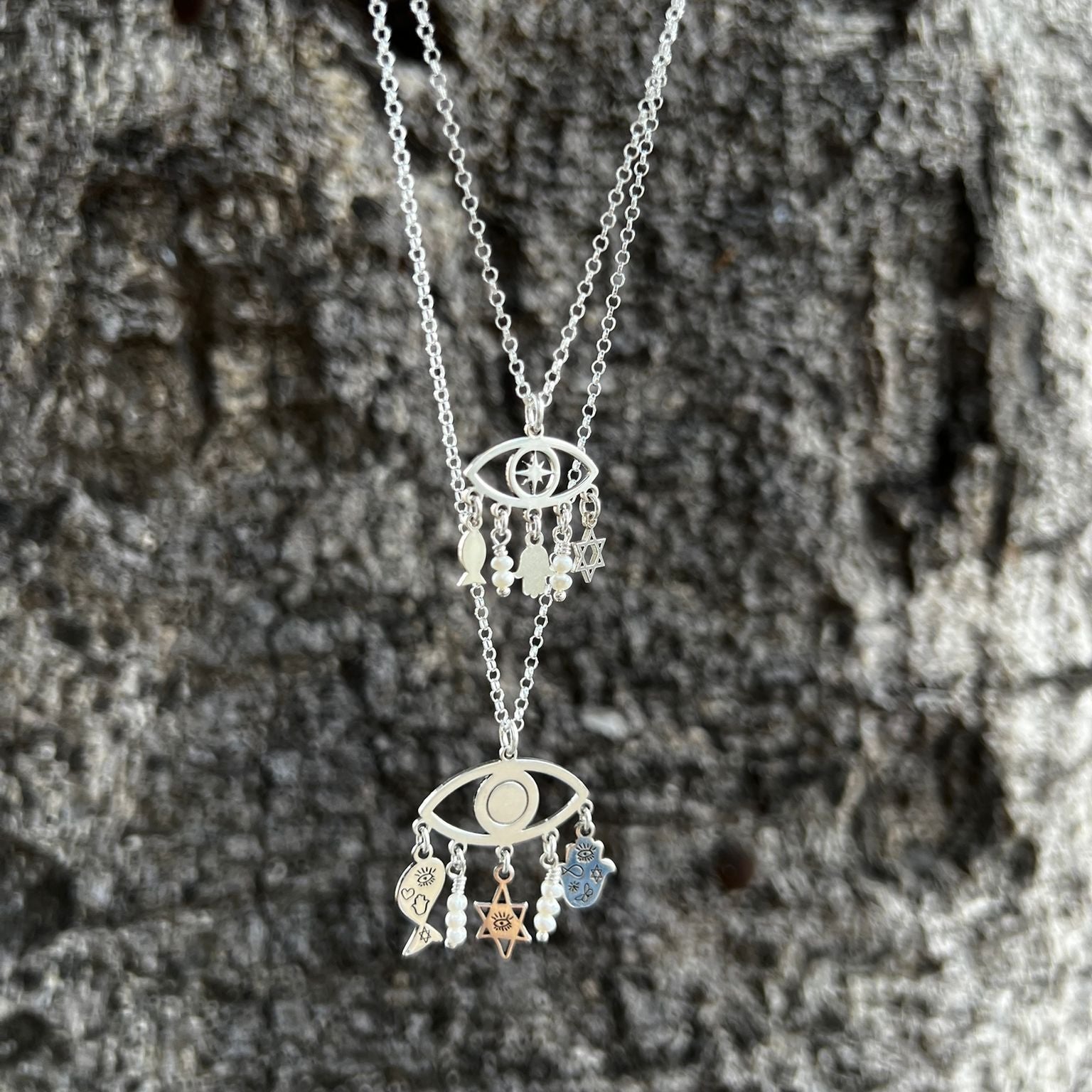 Sterling Silver Charms of Israel hanging on the protection symbol eye. Fish, Star of David, Hamsa. - Bluenoemi