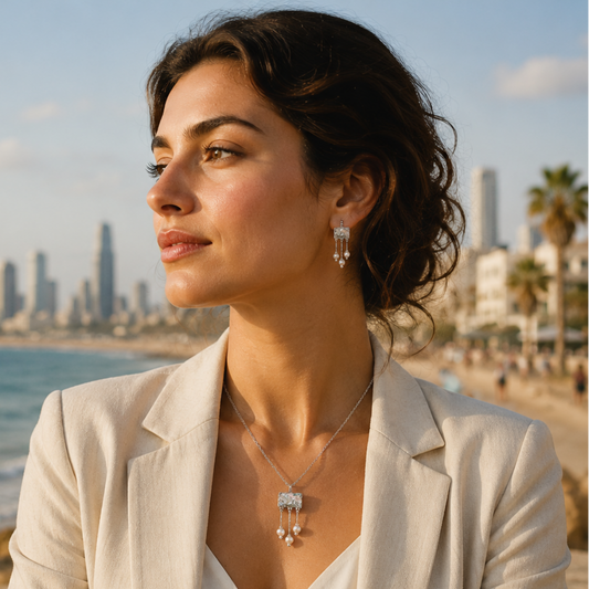 Woman standing on a beach with a city skyline in the background, wearing a necklace.