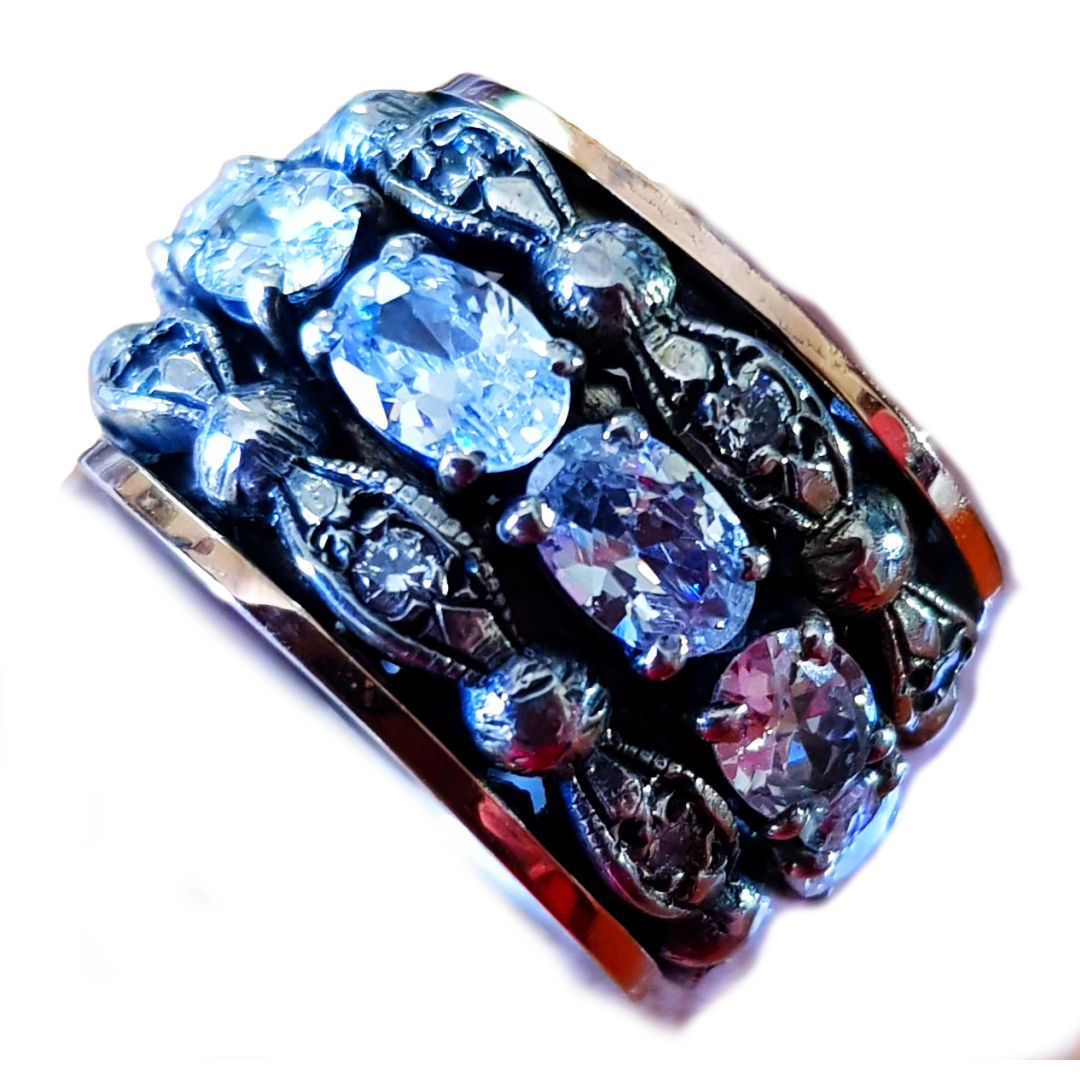 Bluenoemi rings Spinner ring for woman made of silver and gold. The ring is set with cz zircons.